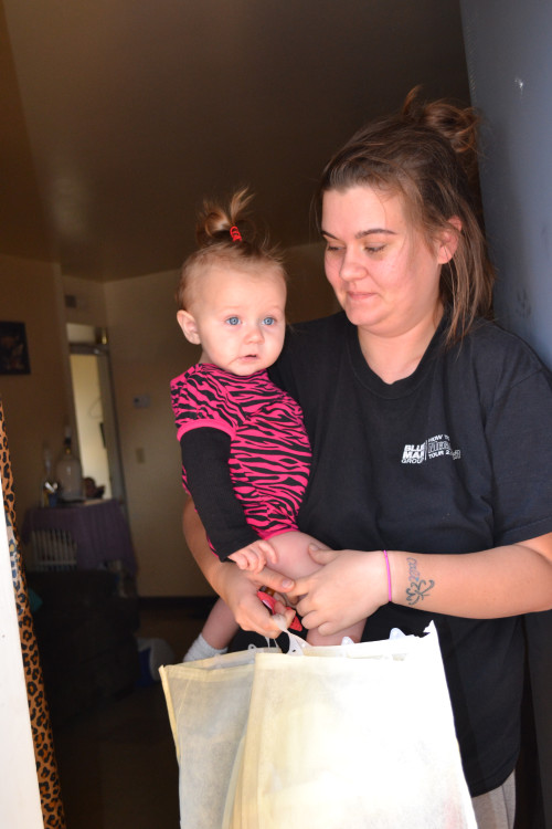 Baby receiving her Stocking of Love and being held by her mom